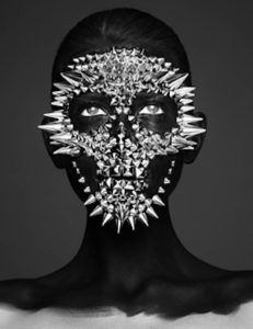 Death Spikes, Mask II by Eankin, portrait of a model painted black, silver spikes forming a skull mask over her face