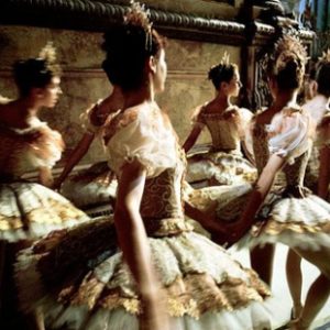 Ballet by Gérard Uféras, Ballerinas in gold and white tutus and crowns walking on stage
