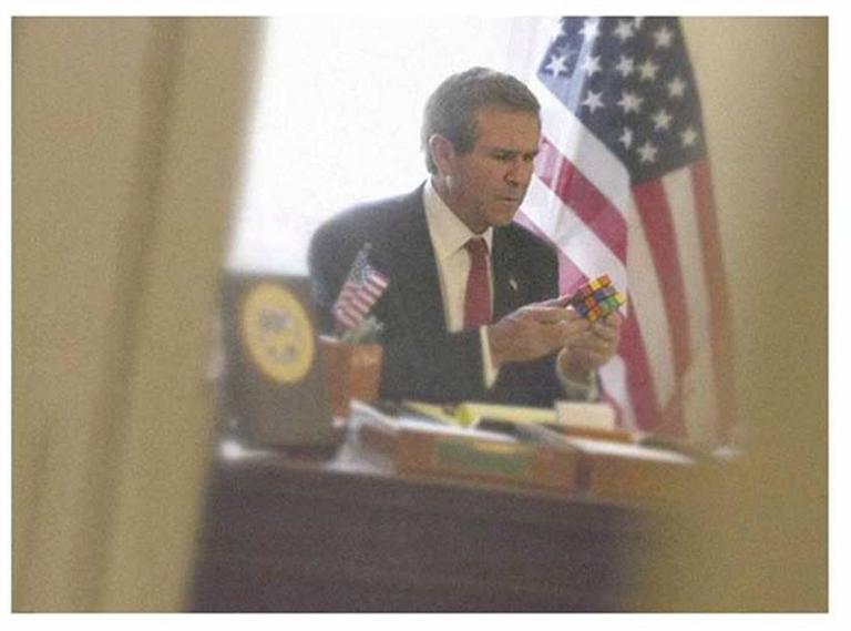 Bush with a Rubix Cube by Alison Jackson, lookalike of the former president playing with a rubix cube