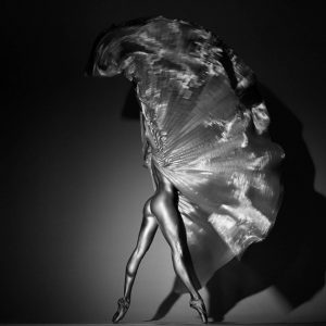 Reutenet by Guido Argentini, nude model in ballet shoes with silver cap, twirling