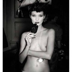 Kate Moss at Vivienne Westwood by Roxanne Lowit, the model topless in a pirate hat, eating icecream