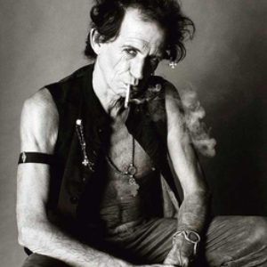 Keith Richards by Sante D'orazio, black and white portrait of the smoking musician in a black vest