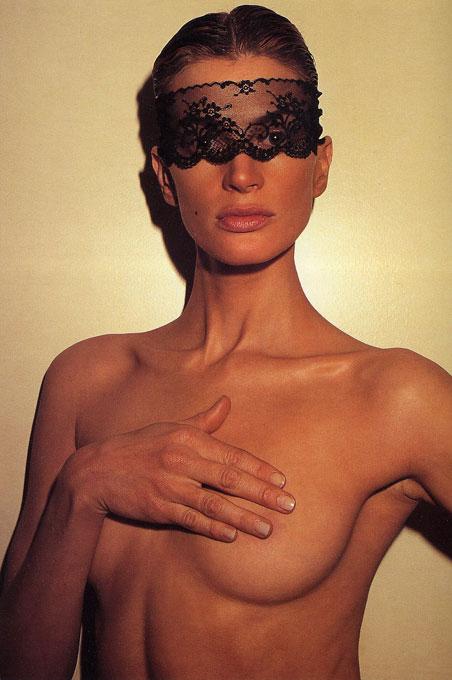 Kristen McMenamy, Paris by Roxanne Lowit, portrait of nude model in black lace mask, covering her breasts with her hand