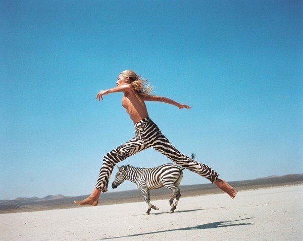 Beauty and Beast II by Michel Comte, Helena Christensen jumping in Zebraprint pants, with Zebra