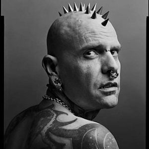 Samppa by Mark Seliger, black and white portrait of tattoed man with septum piercing and spike death hawk