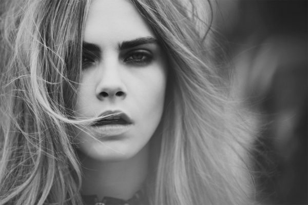 Cara Delevigne by Guy Aroch, black and whitre closeup portait of the model with messy loose hair