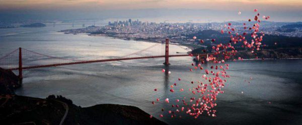 Balloons over San Francisco by David drebin, pink and red balloons floating ove the golden gate with the golden gate bridge in the background