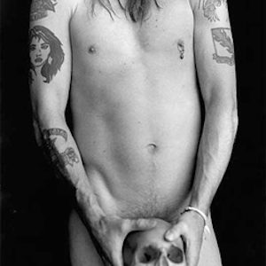 Axl Rose with Skull, Malibu by Sante D'Orazio, black and white photography of the nude musicians torso, covering himself with a human skull