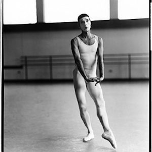 Deni Laumaunt, New York City Ballet by Arthur Elgort, male dancer in white shirt and tights in the practice room
