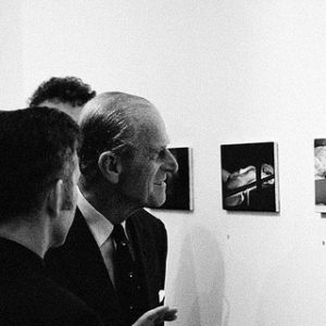 Phillip looking at Marylin by Alison Jackson, Prince Phillip Lookalike looking at a fake picture of Marylin monroe masturbating