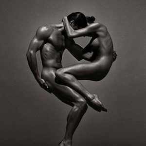 Sina & Anthony, Vienna. 1995 by Andreas H. Bitesnich, nude male and female model joined in acrobatic pose creating a circle
