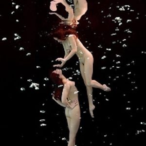 Underwater Study 2517 by Howard Schatz, two nude models floating in dark water between airbubbles