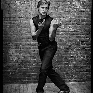 mikhail baryshnikov 2, in my Stairwell by Mark Seliger, the dancer and coreographer in black pants and shirt posing in front of a brick wall