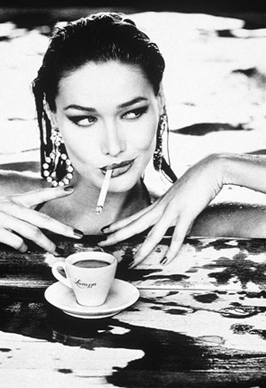 Carla Bruni by Ellen von Unwerth, the Model in a pool with an espresso cup, cigarette and big earrings