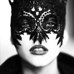 Nadja Auermann, the Mask by Ellen von Unwerth, closeup portrait of the Model in a black lace mask