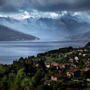 Escape to Lake Como by David Drebin, landscape of the lake with surrounding mountains and villages