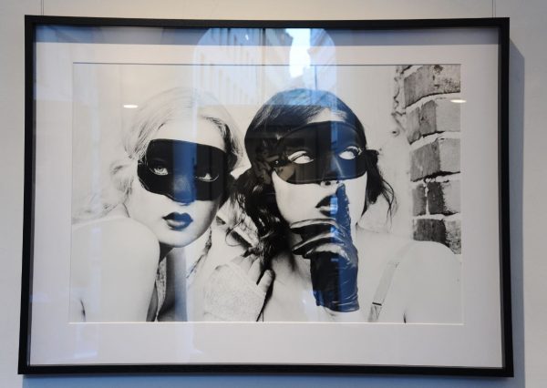 Mimi and Ivy by Ellen von Unwerth, portrait of two models in gloves and black masks framed black