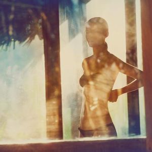 Linda 5 by Guy Aroch, model in black bikini through a window