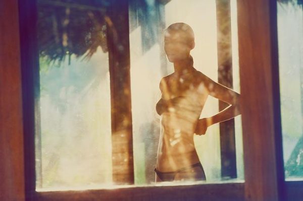 Linda 5 by Guy Aroch, model in black bikini through a window