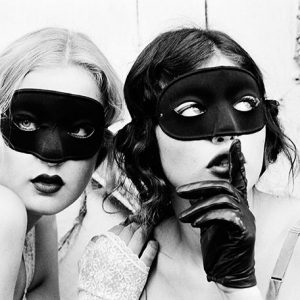 Mimi and Ivy by Ellen von Unwerth, portrait of two models in gloves and black masks