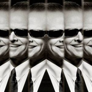Jack Nicholson by Albert Watson, portrait of the actor in suit with sungalsses and cigarette, through several mirrors
