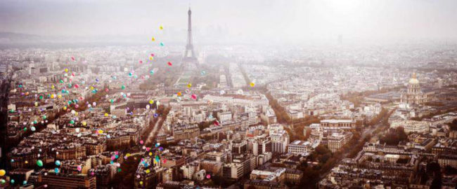 Balloons over Paris by David Drebin, colorful balloons floating over the city with the eifeltower in the back