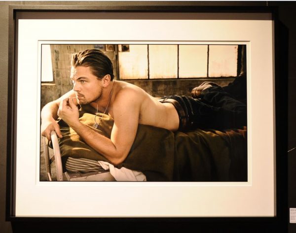 Leonardo DiCaprio, Los Angeles. 2008 by Mark Seliger, the actor lying on a military bed in jeans, shirtless, framed black