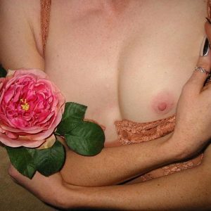 Celests Touch 4 by Iris Brosch, closeup of a models nude chest with pink rose