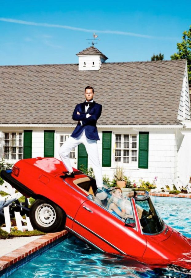 Carpool by Tony Kelly, a red car halfway in a pool, a modle behind the wheel, taking a selfie and a man in suit standing on top of the car