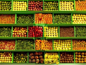 Hiding in Venezuela, Tropical Fruit by Liu Boilin, the artist painted to match the background of a fruit market