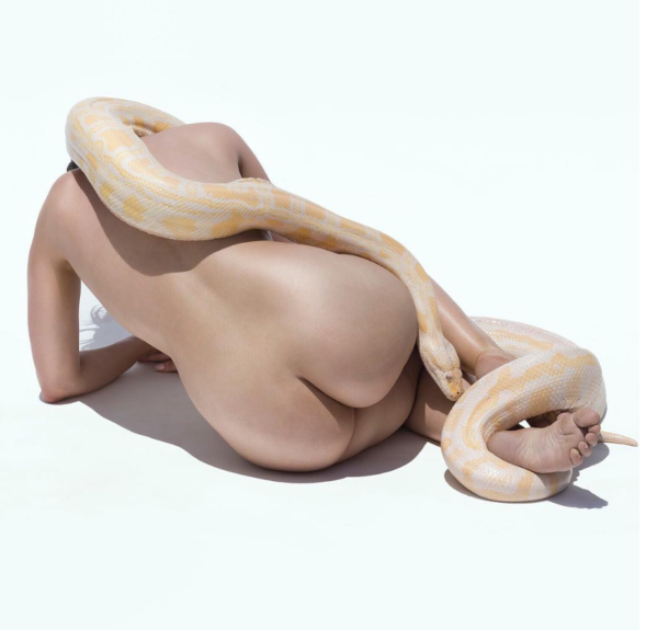 Giant Albino Python I. 2017 by Sylvie Blum, Nude model crouching on the floor, a white and yellow snake draped over her body