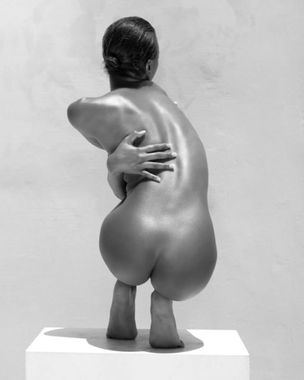 Chocolate Girl III - Vel posing on white box by Sylvie Blum, nude model crouching, from the back