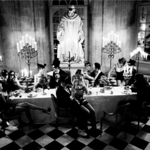 Bon Appetit, from the story of Olga by Ellen von Unwerth, a banquet with men in suits and women in lingerie
