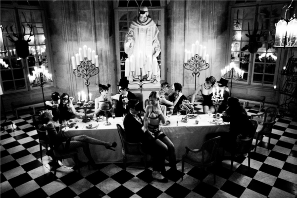 Bon Appetit, from the story of Olga by Ellen von Unwerth, a banquet with men in suits and women in lingerie