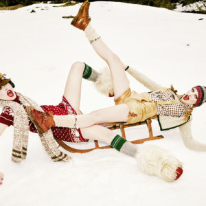 Heimat XI, Sleigh Play, 2015 by Ellen von Unwerth, two models in traditional german dress playing on a wooden sleigh in the snow