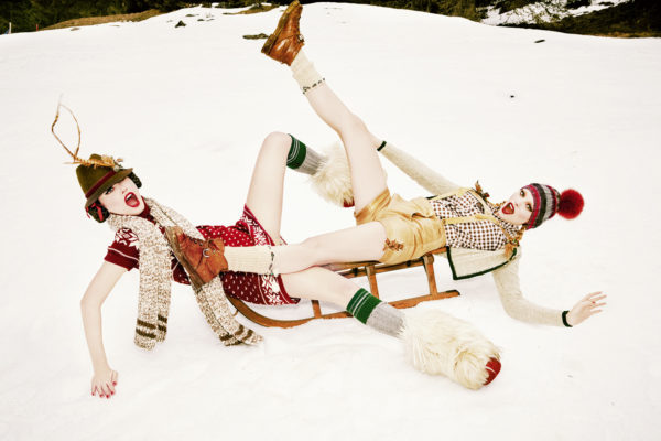 Heimat XI, Sleigh Play, 2015 by Ellen von Unwerth, two models in traditional german dress playing on a wooden sleigh in the snow