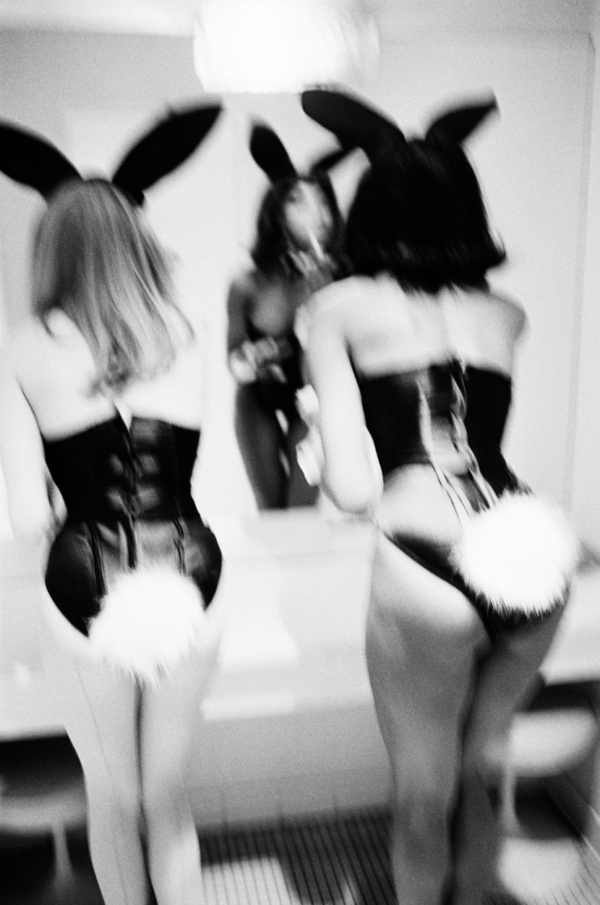 Playboy Bunnies by Ellen Von Unwerth, blurry image of two models in bunny costumes fixing their makeup in a mirror
