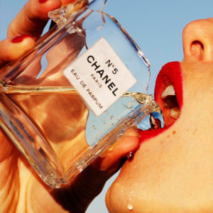 Hot Shot by Tony Kelly, Model in red lip drinking from a broken Chanel No 5 bottle