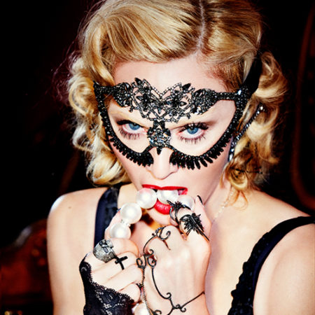 Madonna, material girl by Ellen von Unwerth, the singer with a pearl necklace dressed in black lace.