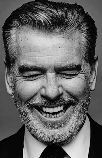 Pierce Brosnan by Nigel Parry, close up portrait of the actor laughing