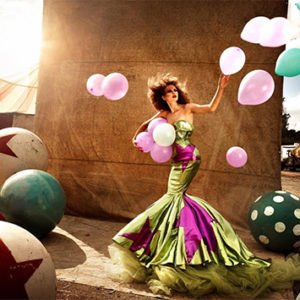 Circus II by Christian Schuller, model in gren and pink mermaid dress with pink and green balloons