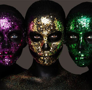 Sparkling Death Masks by Rankin, porttrait of three models painted black, with glitter skulls on their faces in pink gold and green