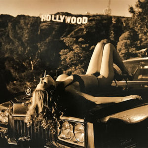 Hollywood Cadillac by Guido Argentini, model in black underwear and heels lying on