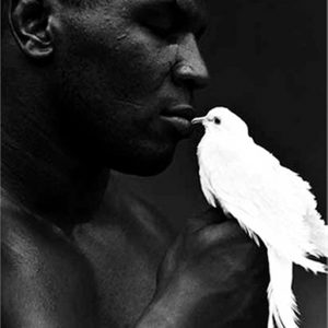 Mike Tyson with Dove by Michel Comte, the boxer in sideprofile holding a white dove