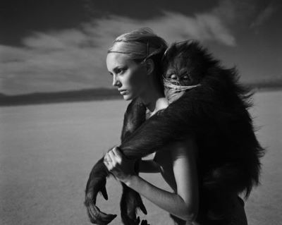 Beauty and Beast I 1996 by Michel Comte, Model and monkey piggyback in the desert