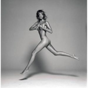 Helena Christensen Jumping by Michel Comte, nude model jumping, covering her breasts with her hands