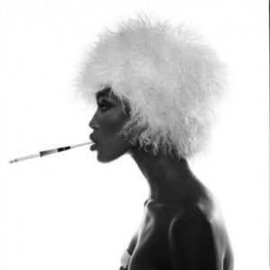 Naomi Campell B&W by Michel Comte, the model in side profile in white afro, smoking