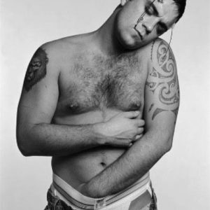 Robbie Williams by Michel Comte, portrait of the singer topless one hand in his underwear
