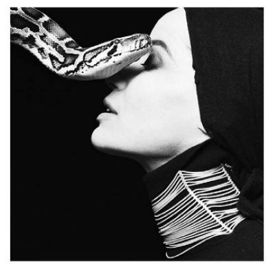 Veruschka Snake by Michel Comte, model in side profile in turtleneck and headscarf, wearing a big choker, a snake next to her face