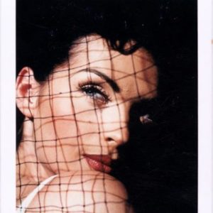 ALLA, Vienna 1992 by Bruno Bisang, potrait of model in black hair and red lip, behind a net